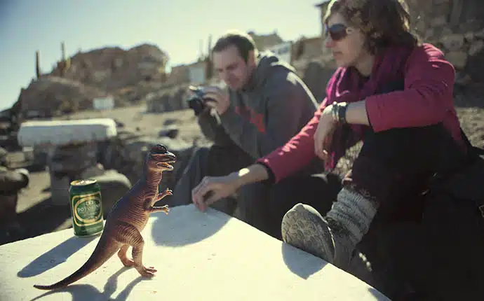 Dinosaur and beer can on salt flats