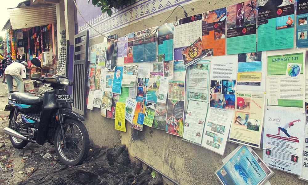 Noticeboard and motorbike in Ubud