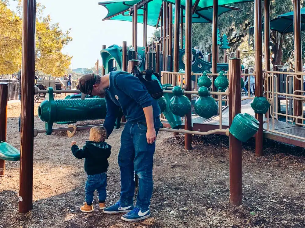 Otis ad Steve playing with instruments at a playground in Forsyth Park