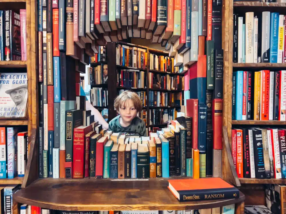 Book sculpture with child peering through at The Last Bookstore LA