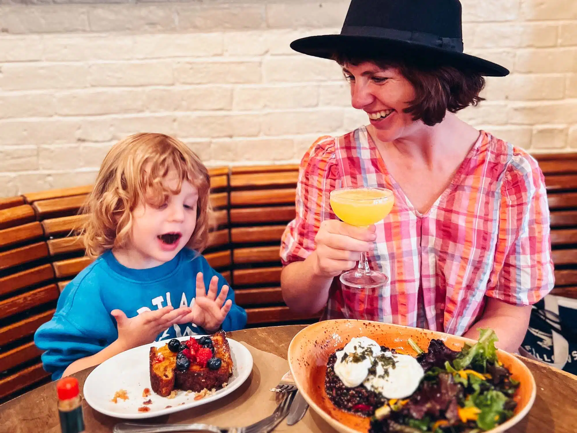 Victoria and son having breakfast in a cafe in Boston