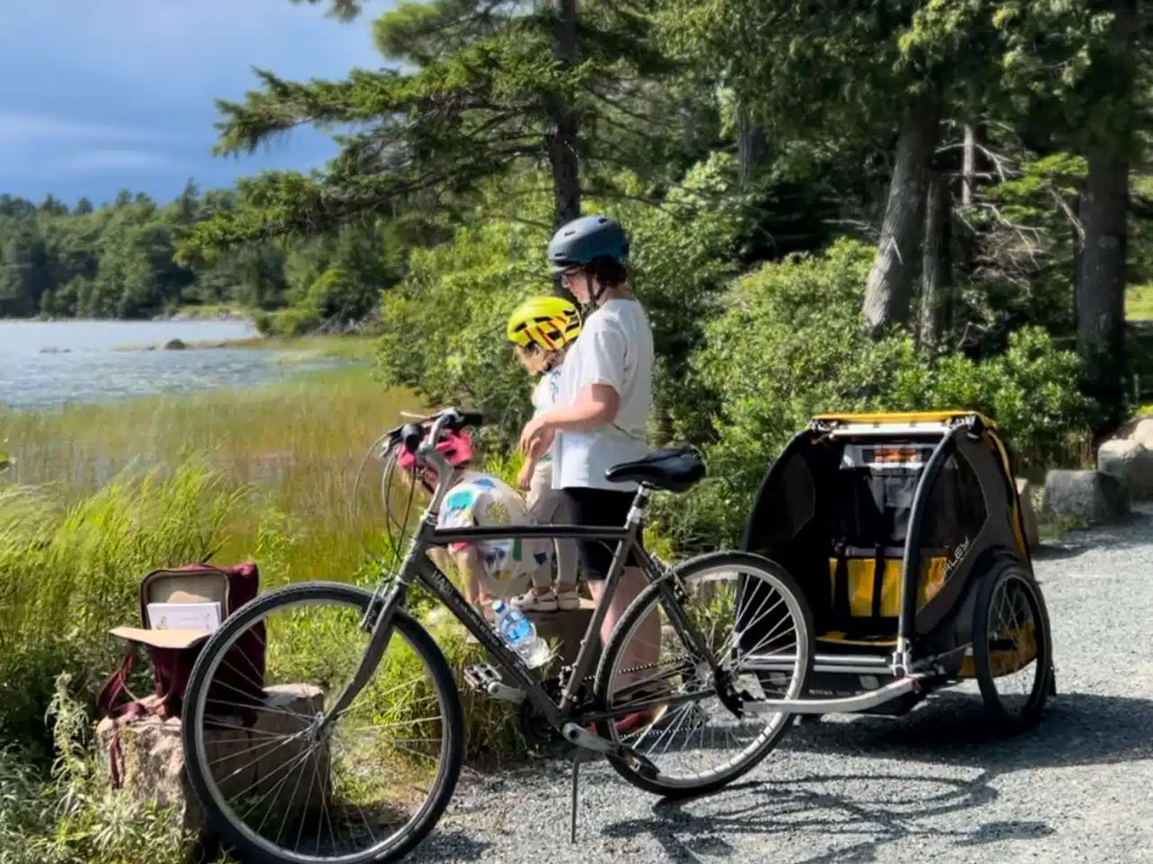 Victoria riding a bike around Acadia National Park