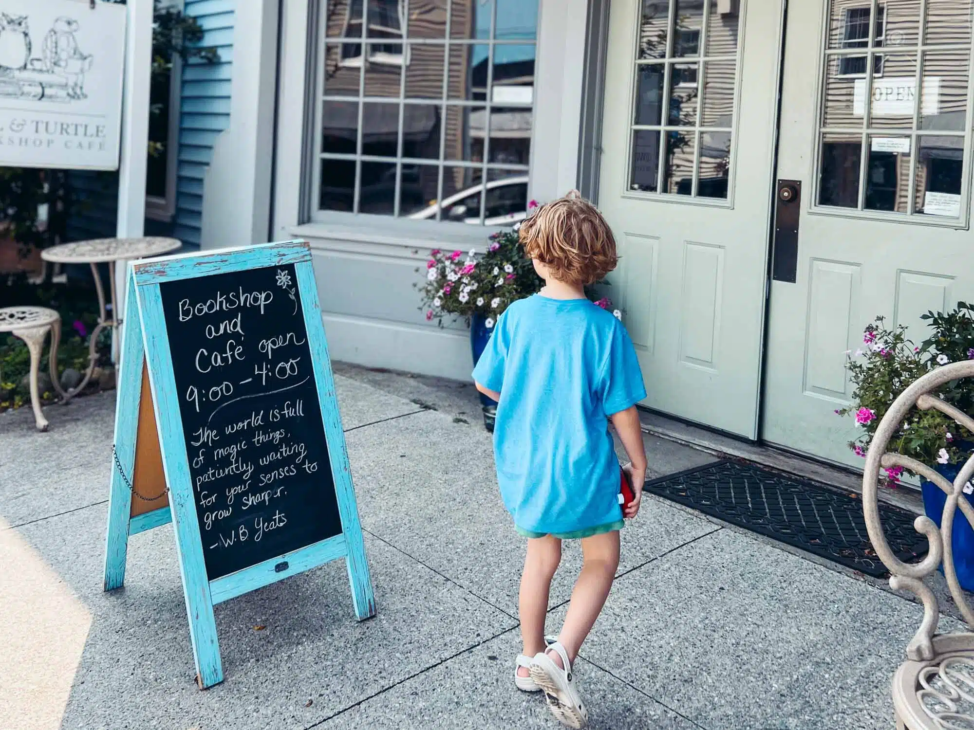 Victoria's son walking to Owl and Turtle Cafe and Bookshop