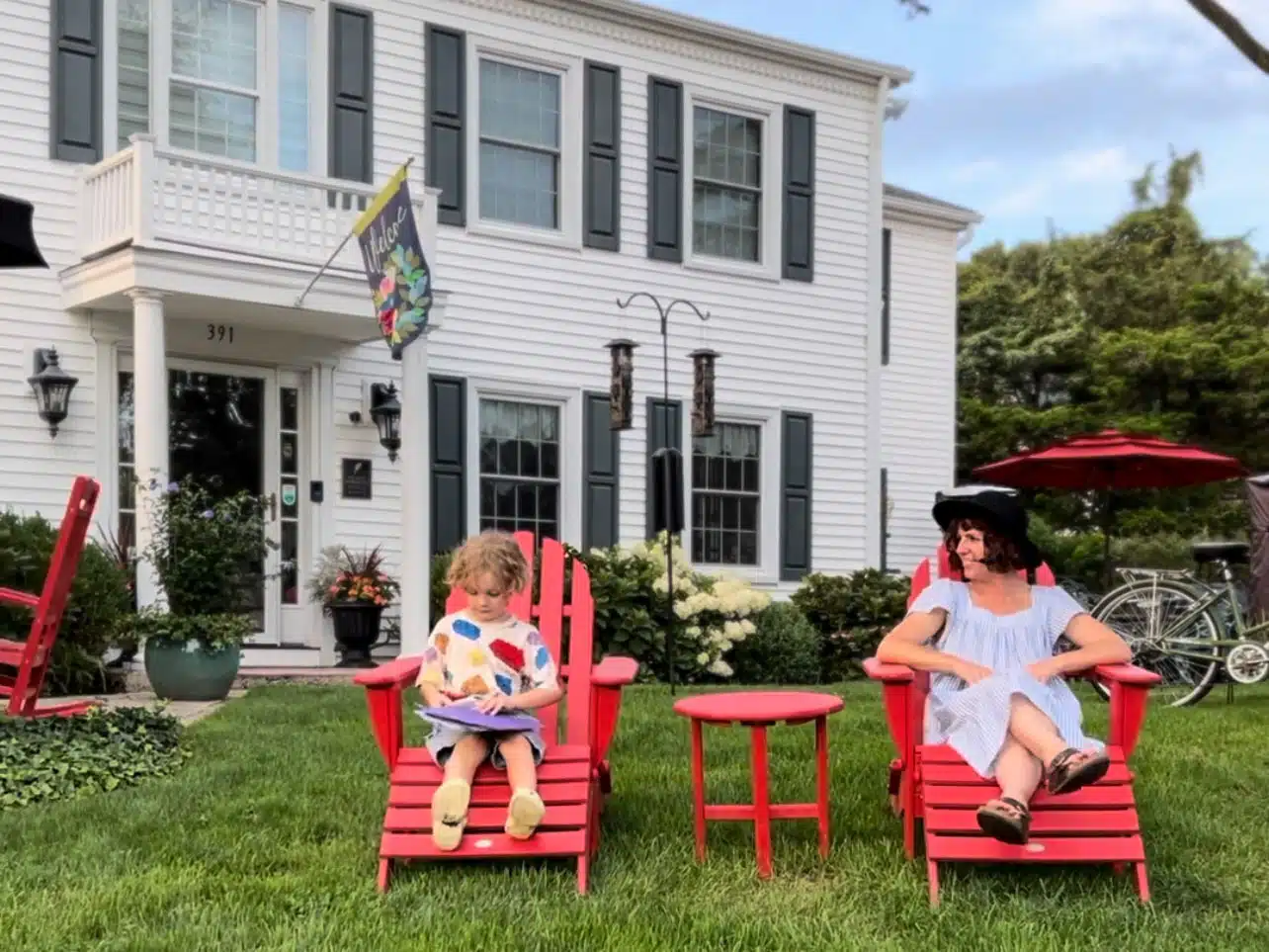 Victoria and Otis sat on red chairs outside Homestead Madison