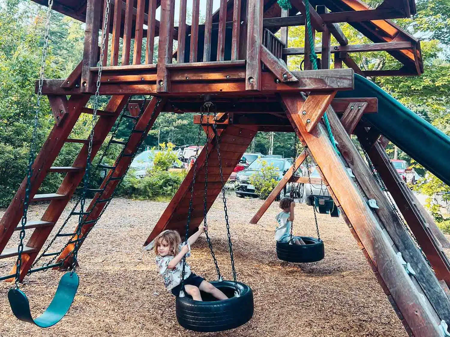Arlo and Otis playing in the playground at Huttopia
