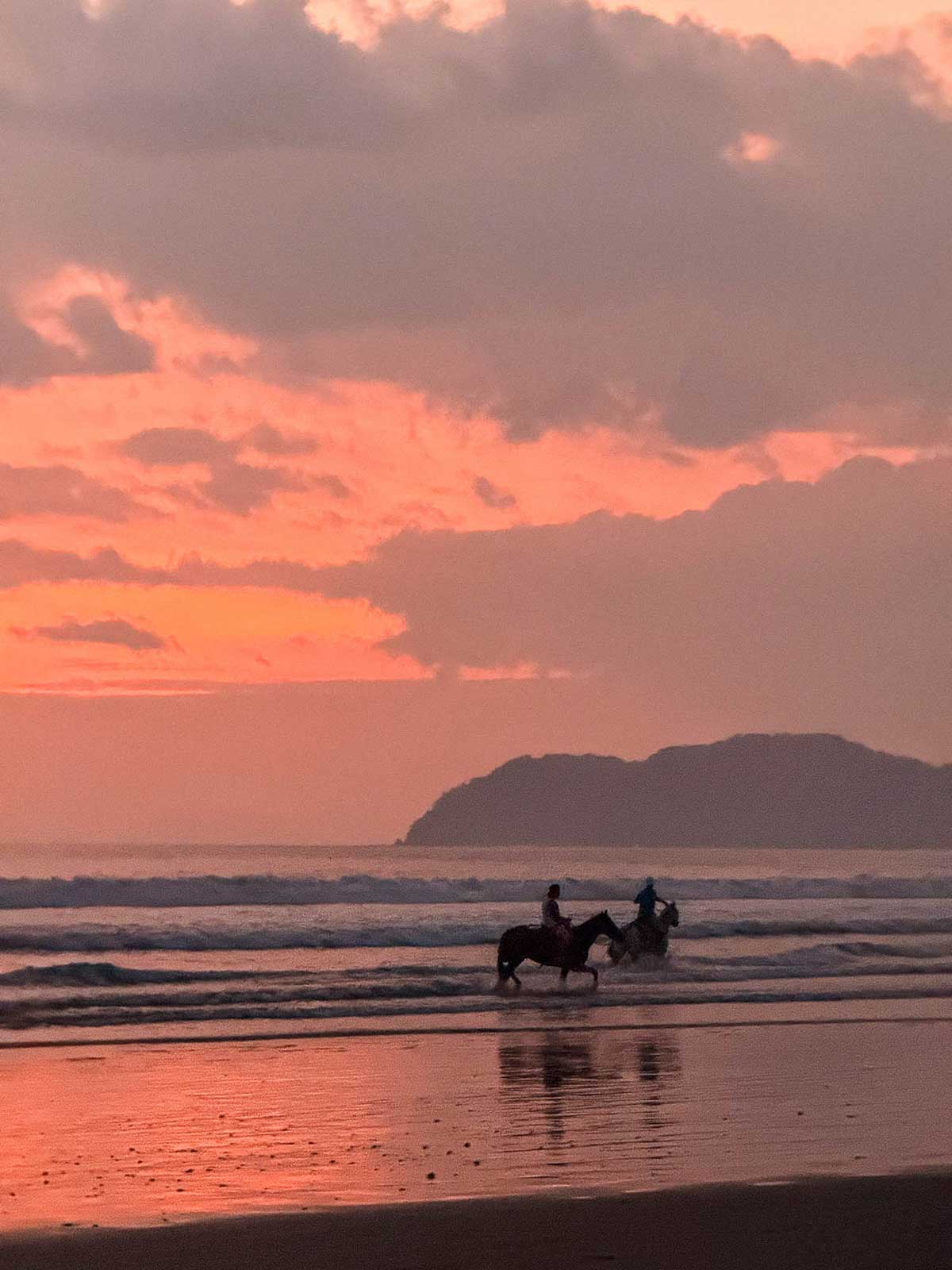 Horse riding at sunset in Jaco, Costa Rica.
