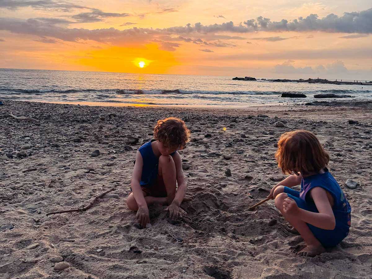 Kids playing on Playa Pelada at sunset, Nosara.