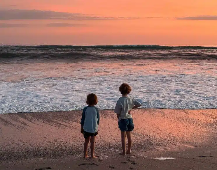 Kids enjoying a beautiful sunset in Santa Teresa Beach.