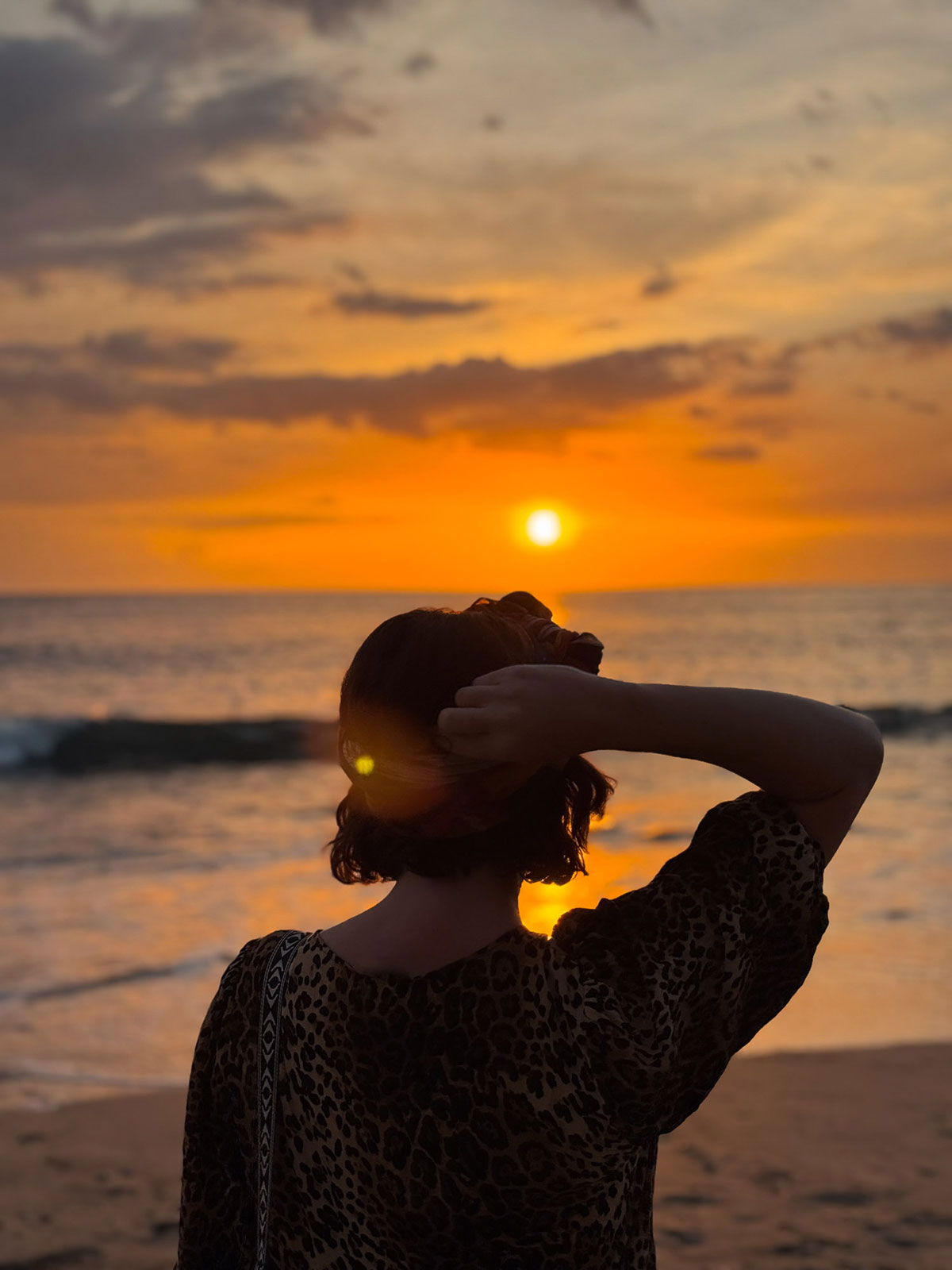 Victoria enjoying the sunset at Playa Pelada, Nosara, Costa Rica.