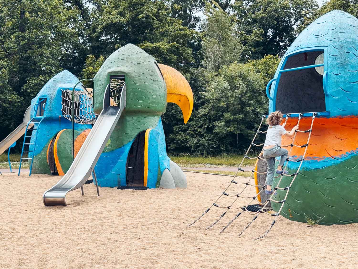Kid playing in the playground at the Orleans Floral Park, Loire Valley.