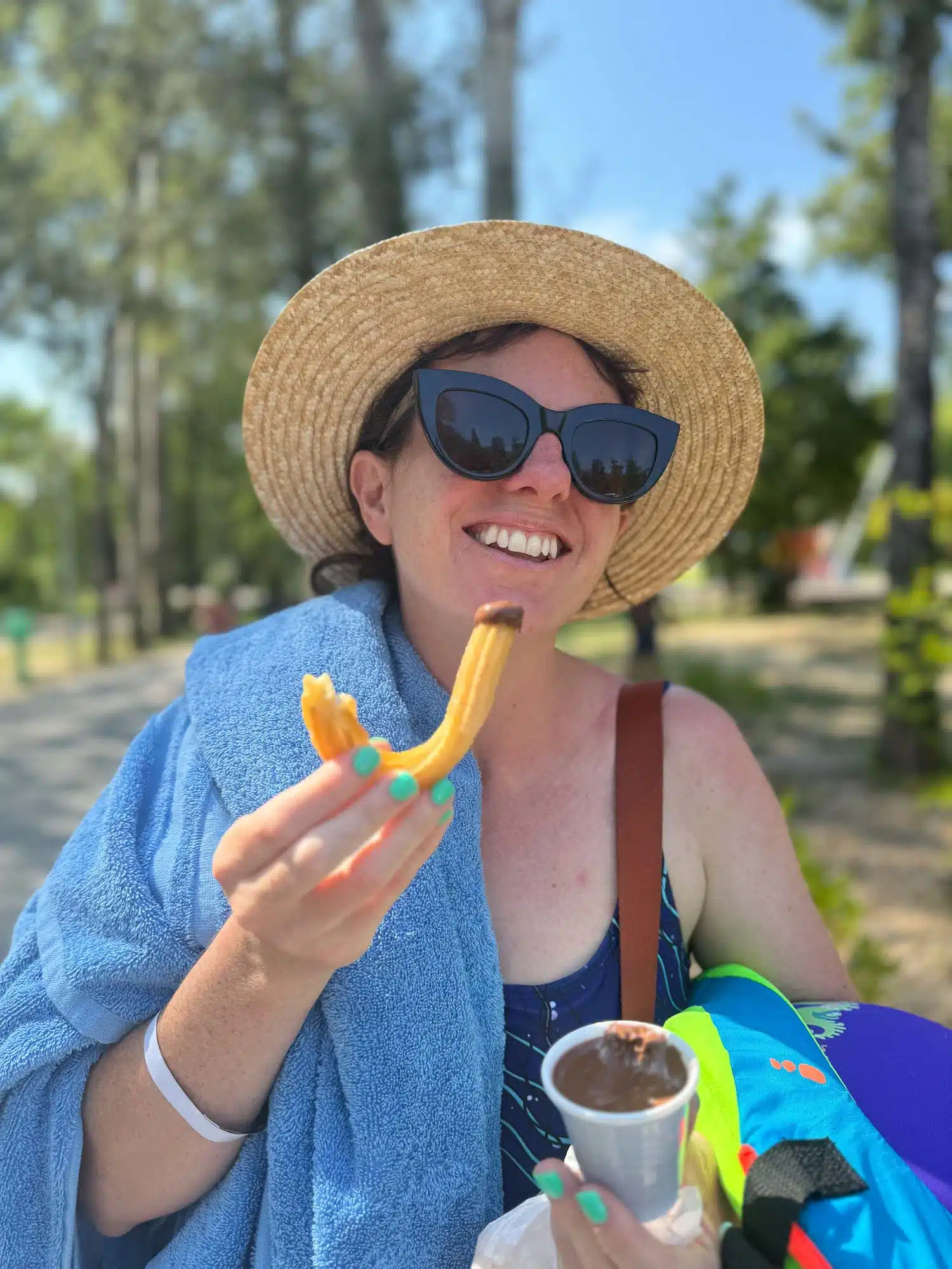 Victoria eating churros with chocolate at Eurocamp Le Pommier.