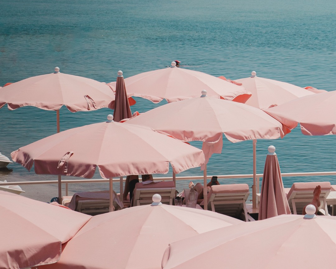 Pool umbrellas and sunbeds at the Cap d’Antibes Beach Hotel.